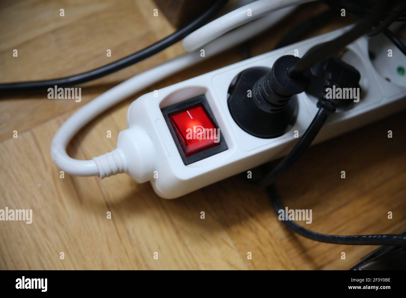 A multiple plug extension cord with the red button on Stock Photo Alamy