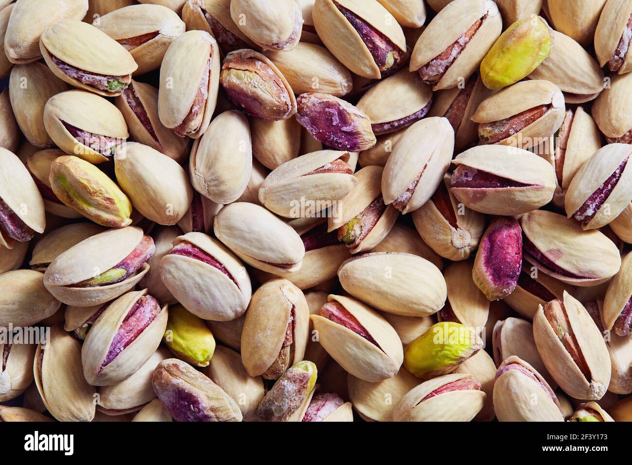 Full frame shot of pistachio nuts. Roasted and salted pistachios ready to eat. Stock Photo