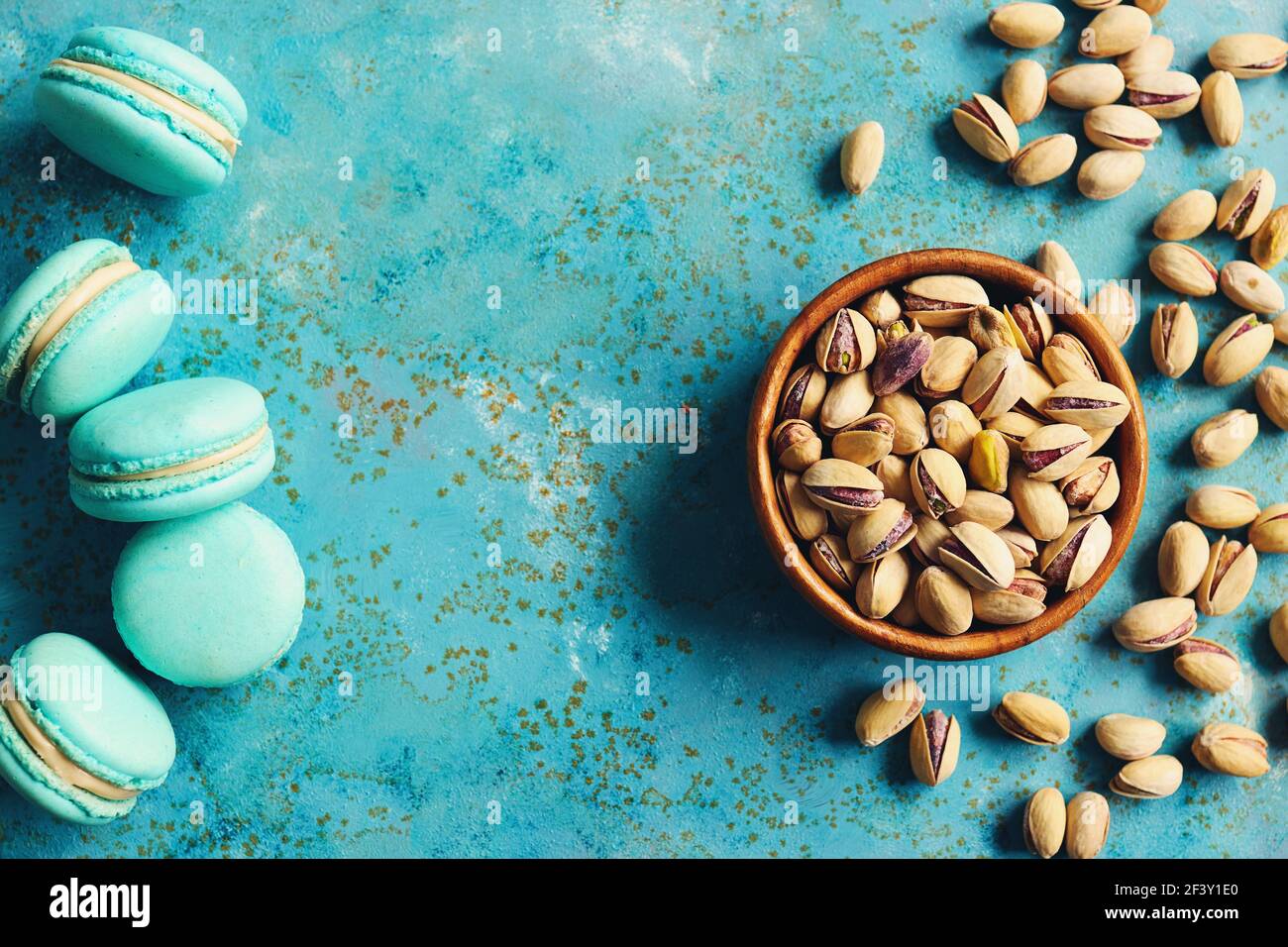 Pistachios in a bowl and pistachio flavored macarons Stock Photo