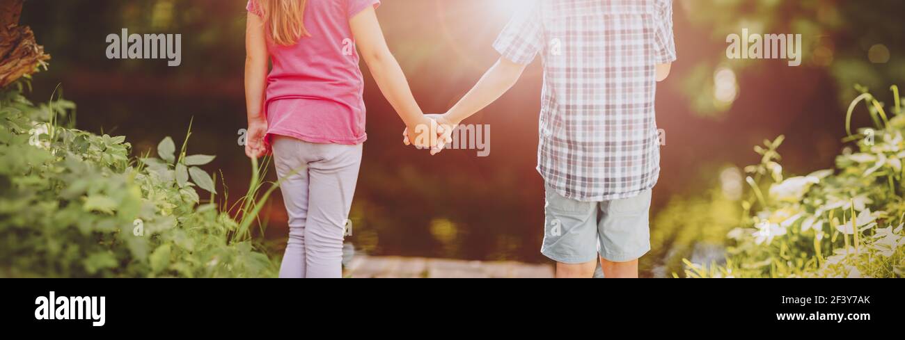 Girl and boy standing together in the park Stock Photo - Alamy