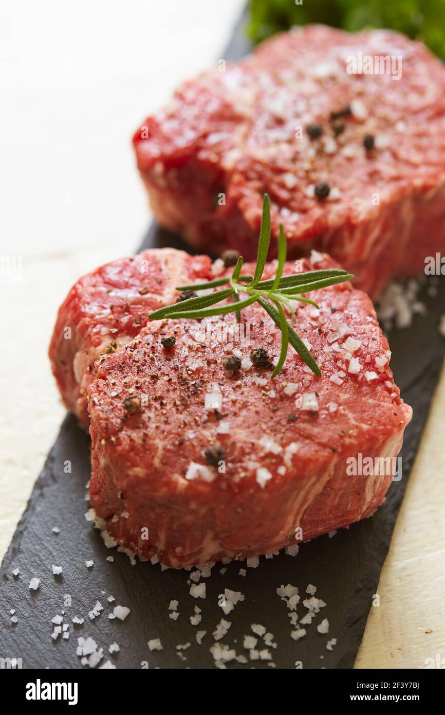 Pepper and coarse salt on whole meat Stock Photo Alamy