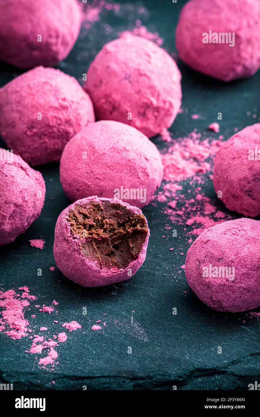Velvety chocolate truffles in freeze dried raspberrycranberry powder