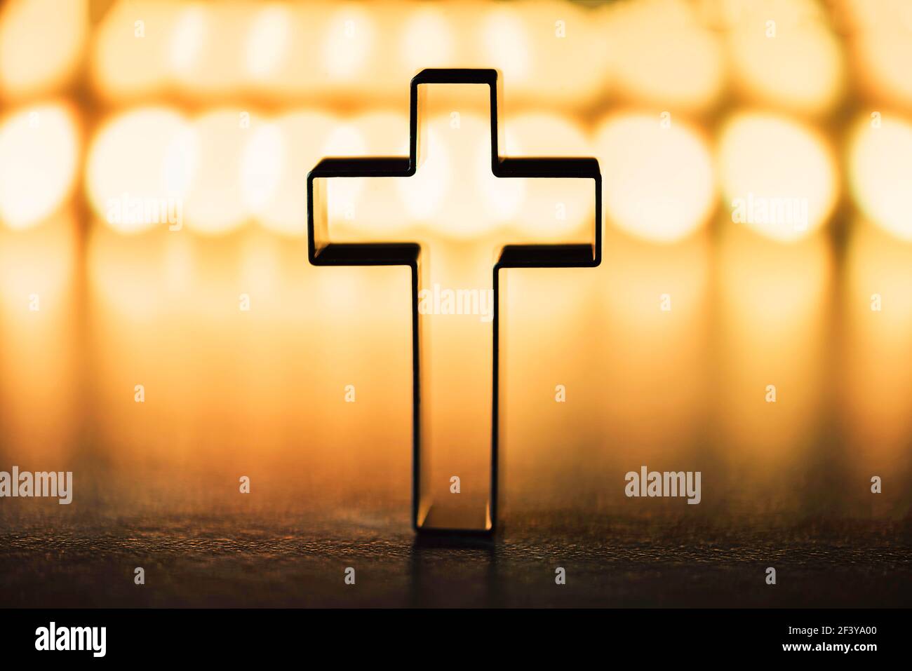 Silhouette of christian cross on yellow background, soft bokeh lights  background. Copy space. Church worship, salvation concept. Faith symbol in  Jesus Stock Photo - Alamy