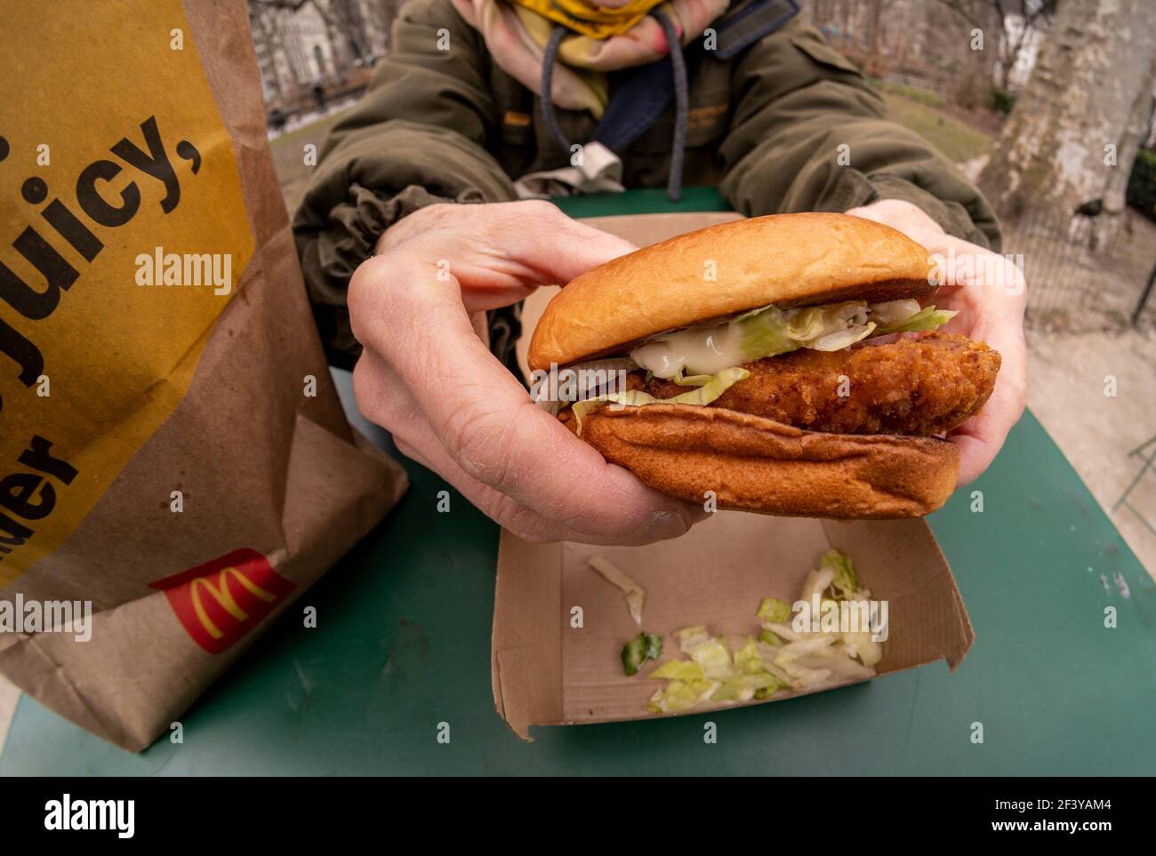 A diner prepares to lunch on a McDonaldâ€™s Crispy Chicken Sandwich Deluxe  while dining al fresco in New York on Wednesday, March 17, 2021. In 2019  Popeyeâ€™s debuted its chicken sandwich to