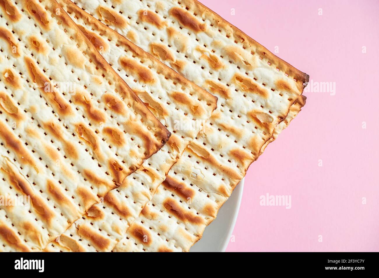 Happy Passover. Matzo on pink background. Traditional Jewish food for