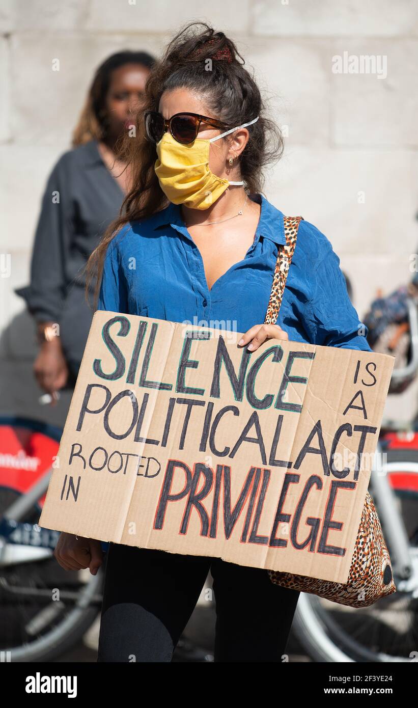 Anti-racism campaigner with sign, at the Black Lives Matter demonstration in London, in protest of the death of George Floyd by US police. Stock Photo