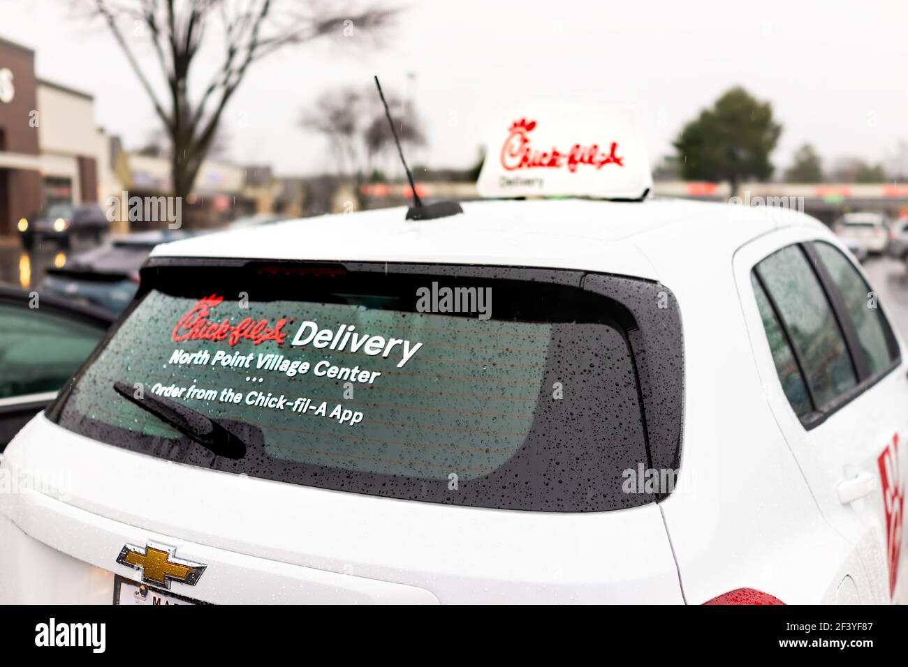 Herndon, USA - December 14, 2020: Chick-fil-a branded delivery car sign delivering online app orders for chicken sandwich food on parking lot of Virgi Stock Photo