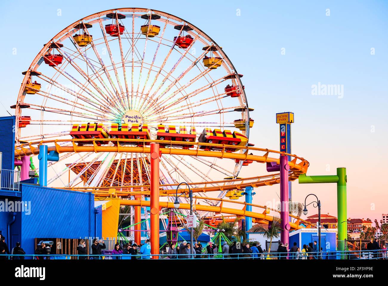 Santa Monica, USA - December 27, 2015: Ferris wheel and roller coaster ...