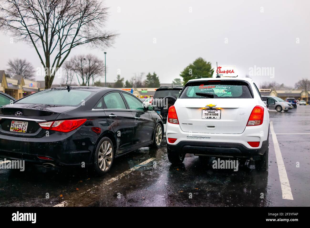 Herndon, USA - December 14, 2020: Chick-fil-a branded delivery car delivering online app orders for chicken sandwich food parked on parking lot of Vir Stock Photo