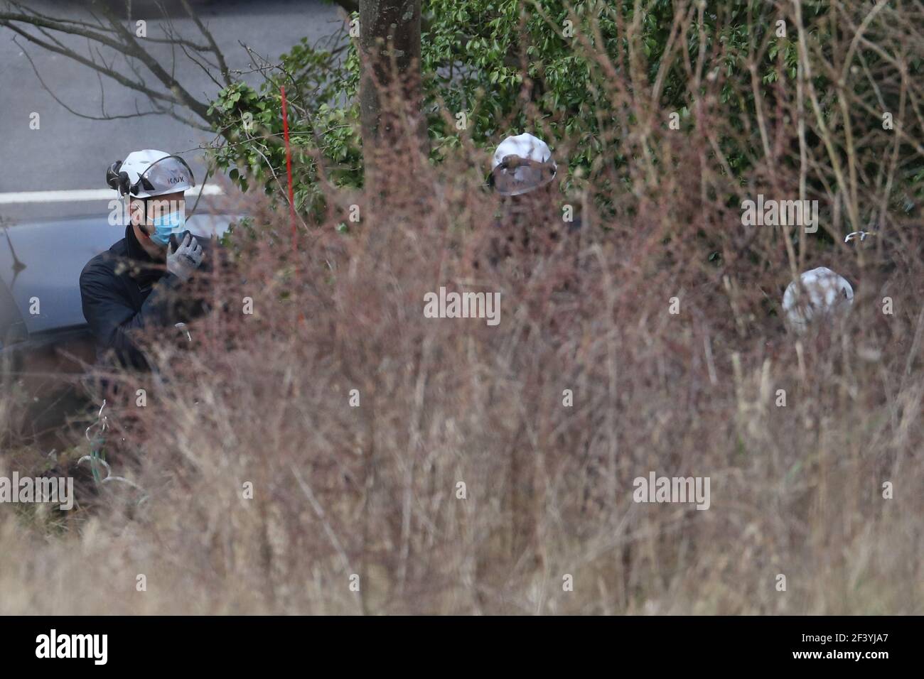 Specialist Police search officers work in scrub land below the Western Heights of Dover in North Military Road, Dover, Kent, where they are continuing investigations into the murder of Sarah Everard. The 33-year-old went missing on March 3 while walking home after visiting a friend in south London. Picture date: Thursday March 18, 2021. Stock Photo