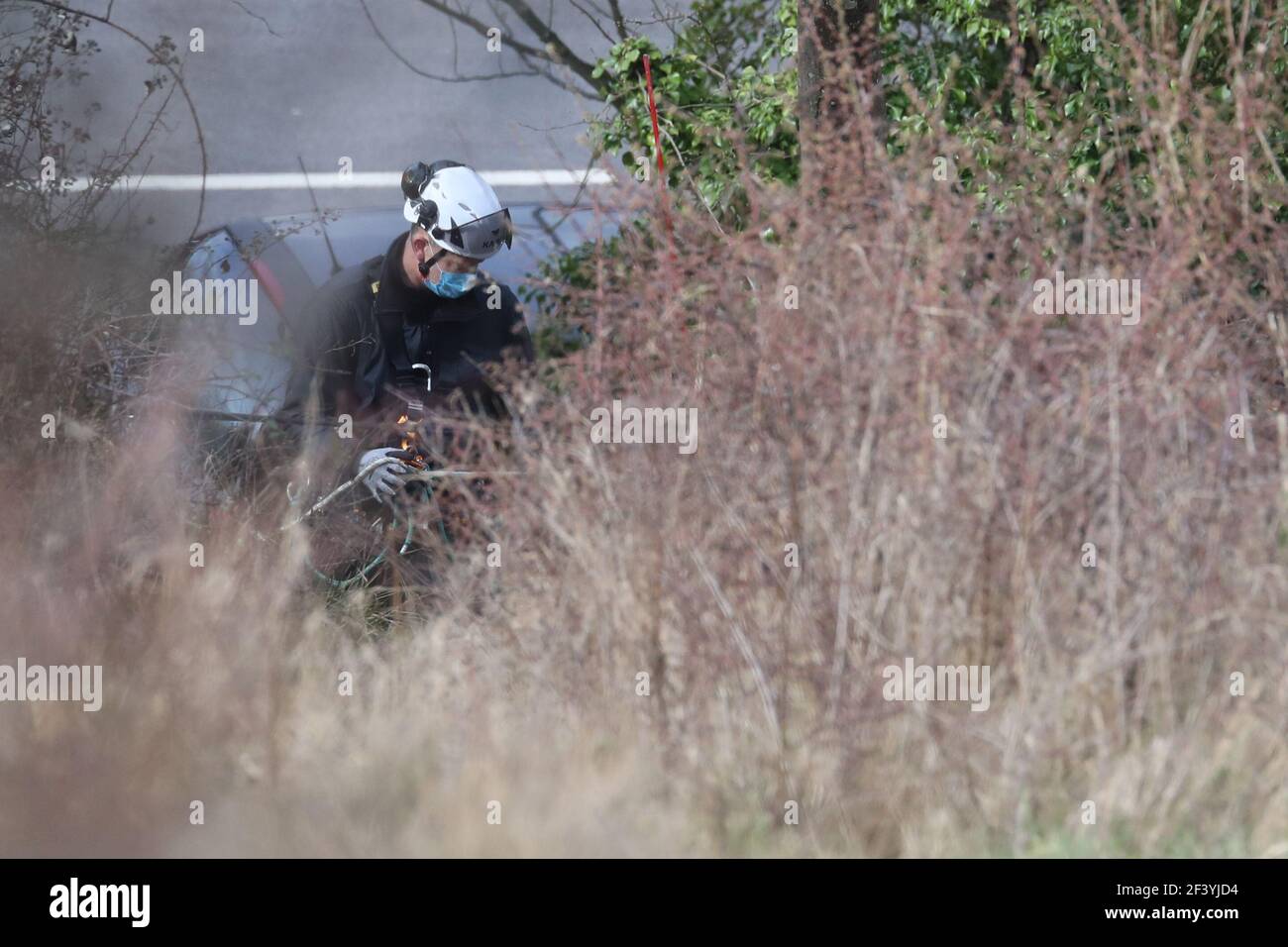 Specialist Police search officers work in scrub land below the Western Heights of Dover in North Military Road, Dover, Kent, where they are continuing investigations into the murder of Sarah Everard. The 33-year-old went missing on March 3 while walking home after visiting a friend in south London. Picture date: Thursday March 18, 2021. Stock Photo