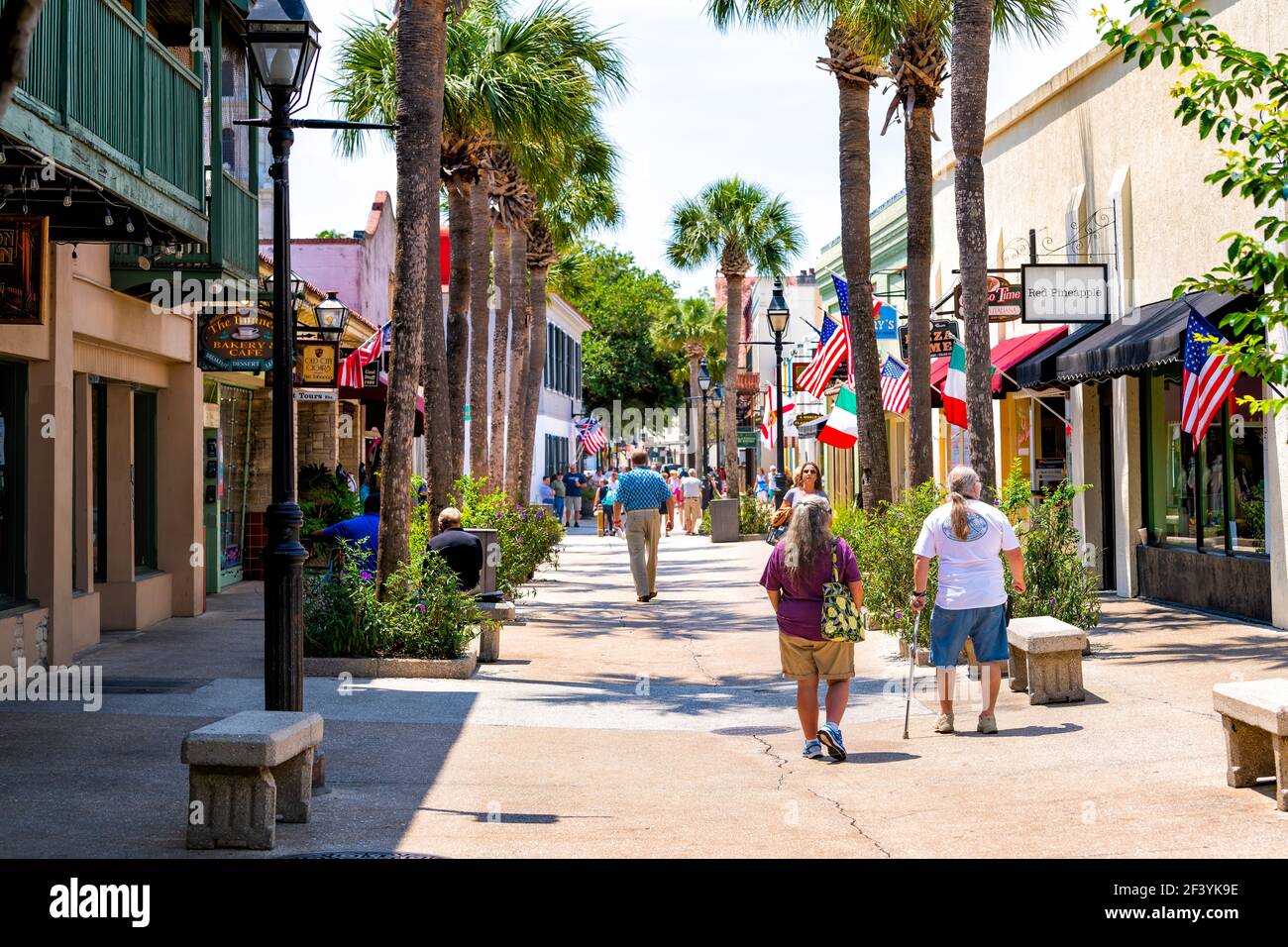 St. Augustine, USA - May 10, 2018: Senior couple walking by St George street sidewalk stores shops, restaurants in downtown old town of Florida city i Stock Photo