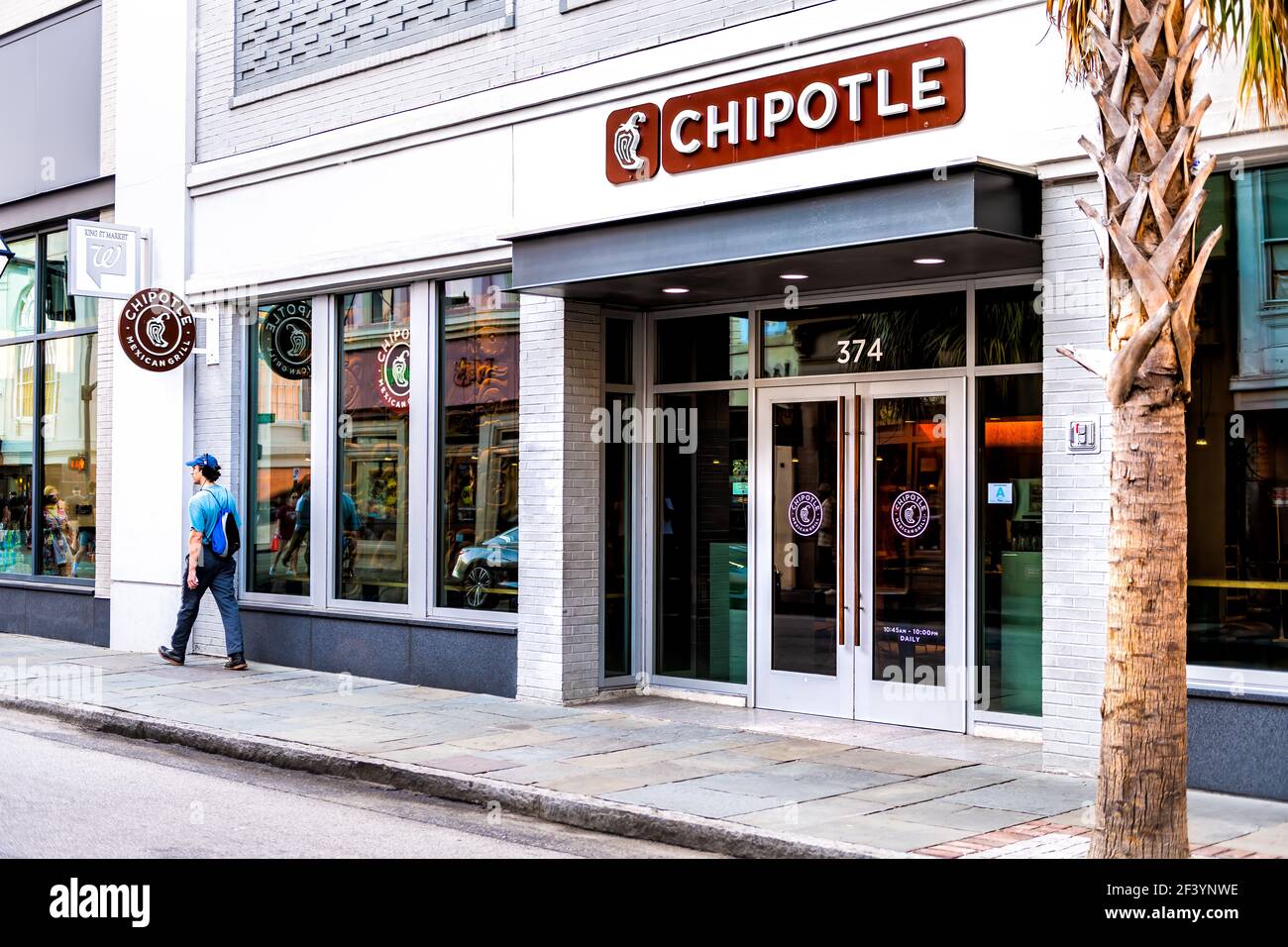 Charleston, USA - May 12, 2018: Chipotle restaurant sign in historic old town of South Carolina French quarter on King street with people Stock Photo