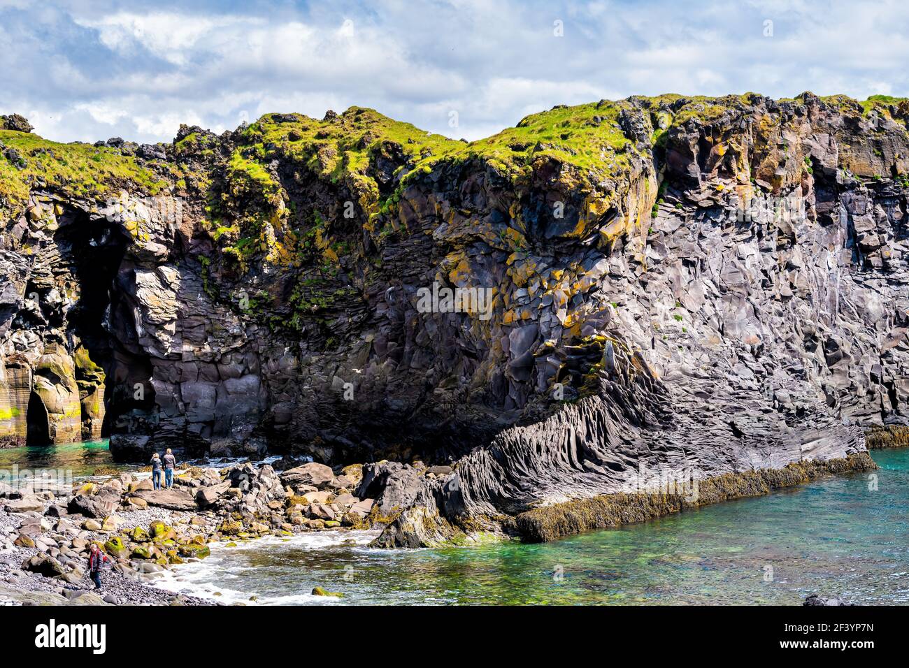 Snaefellsjokull, Iceland - June 18, 2018: View of rocky formation in Hellnar National park Snaefellsnes Peninsula with ocean and cave cove people tour Stock Photo