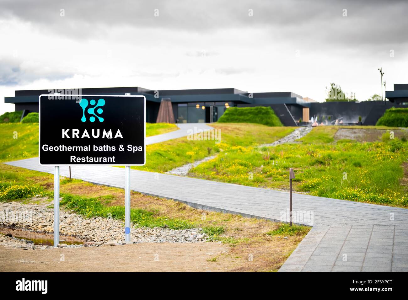Deildartunguhver, Iceland - June 18, 2018: Krauma hot springs resort spa travel building sign text in English and people swimming in hot water outside Stock Photo