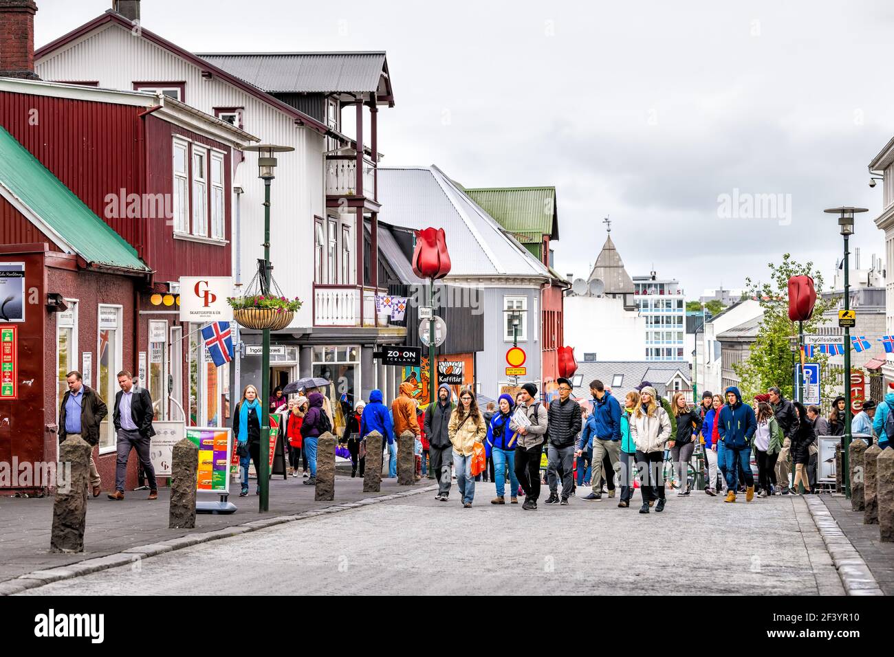 Reykjavik, Iceland - June 19, 2018: Many people tourists walking on street  sidewalk in downtown center by stores shops restaurant with signs in summer  Stock Photo - Alamy