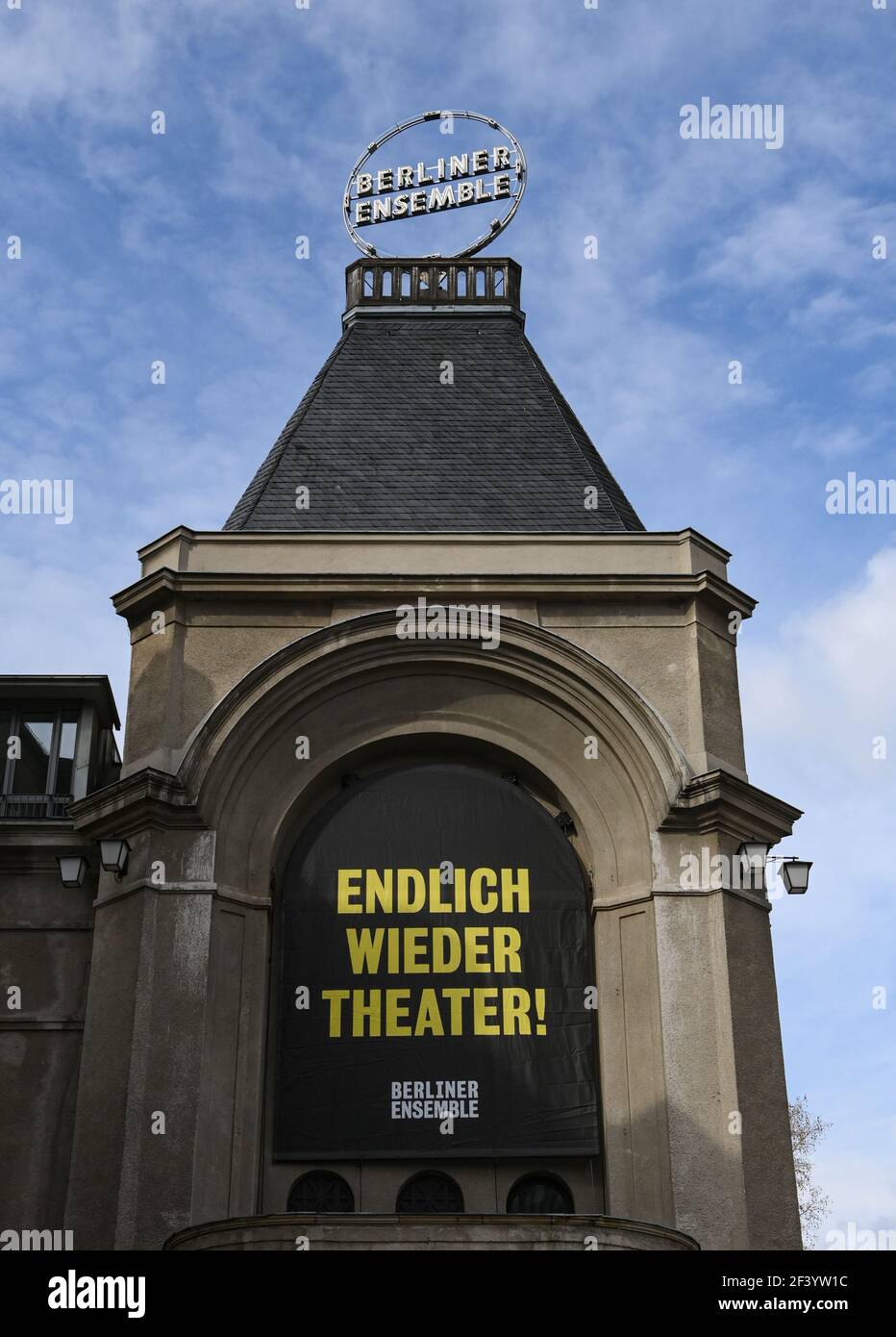 18 March 2021, Berlin: A poster with the words 'Finally, theatre again' hangs on the façade of the Berliner Ensemble. In a pilot project of the Berlin theatres to re-start in Corona times, a performance of 'Panikherz' will be shown on Friday evening at the BE, where the audience had to be tested for the Corona virus in advance. Several establishments want to test out how they might reopen. A total of nine events are planned through early April. Photo: Jens Kalaene/dpa-Zentralbild/dpa Stock Photo