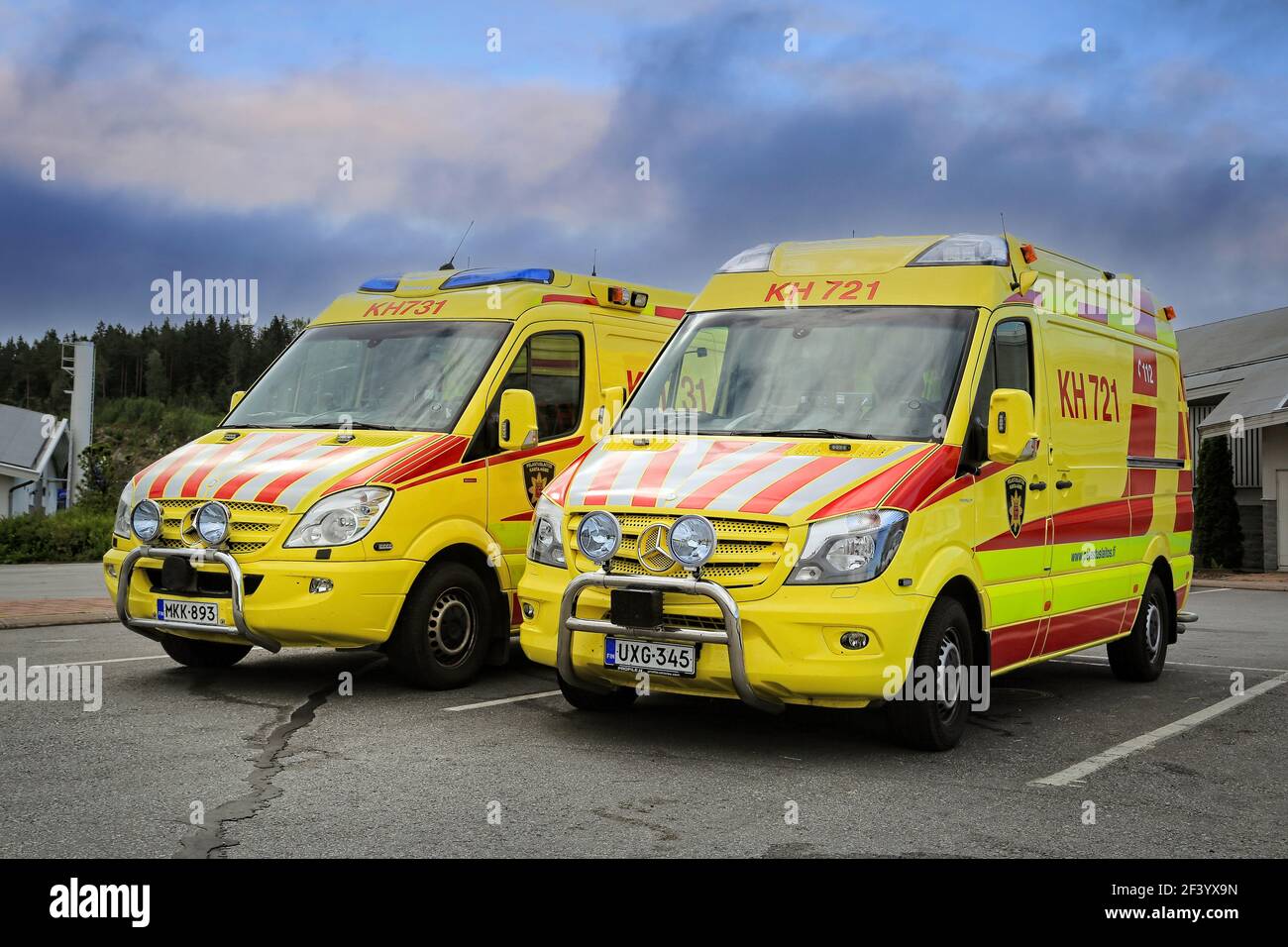 Two Mercedes-Benz ambulance vehicles parked outside a service station. Finland. Stock Photo