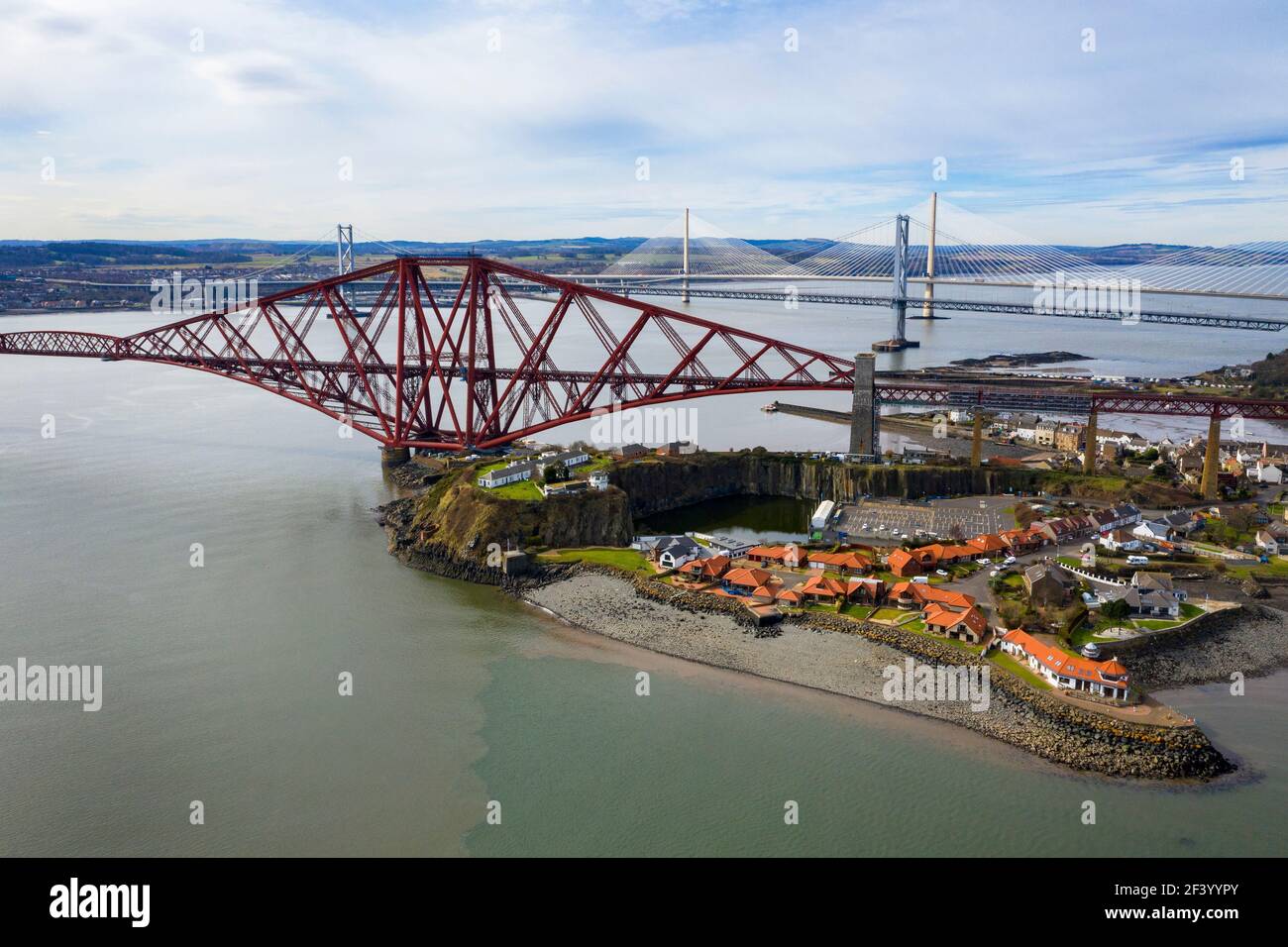 North Queensferry, UK. 18th Mar 2021.  Spring Weather: Panoramic view of the three bridges that span the Firth of Forth at North Queensferry, The Forth Rail Bridge, Forth Road bridge and the Queensferry Crossing. Credit: Ian Rutherford/Alamy Live News. Stock Photo