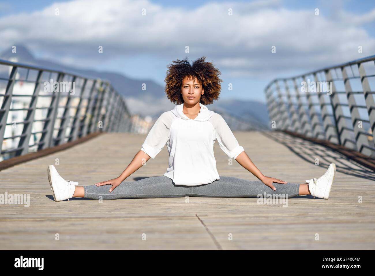 young-black-woman-doing-stretching-after-running-outdoors-girl