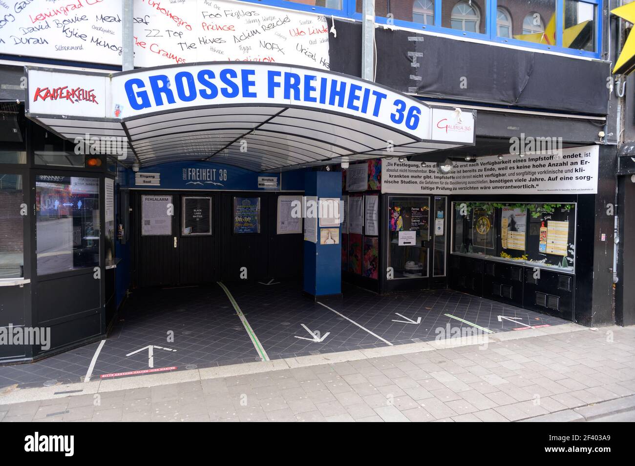 18 March 2021, Hamburg: Several posters about the Corona pandemic are hanging at the entrance of the building of the club 'Große Freiheit 36'. Hamburg's most important concert promoters have announced the boycott of two of the Hanseatic city's neighbourhood clubs in an open letter. In the letter, twelve promoters criticize the clubs Docks and Große Freiheit 36 because of the contents of their wall newspapers in front of their doors. (to dpa: 'Hamburg Kiez-Clubs threatened with organizer boycott') Photo: Jonas Walzberg/dpa Stock Photo