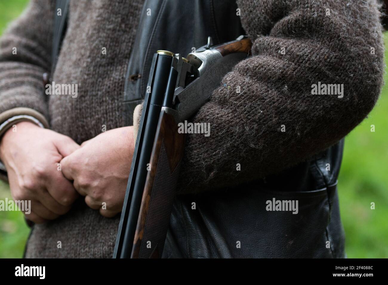 Over and under shotgun in a guns arms Stock Photo - Alamy