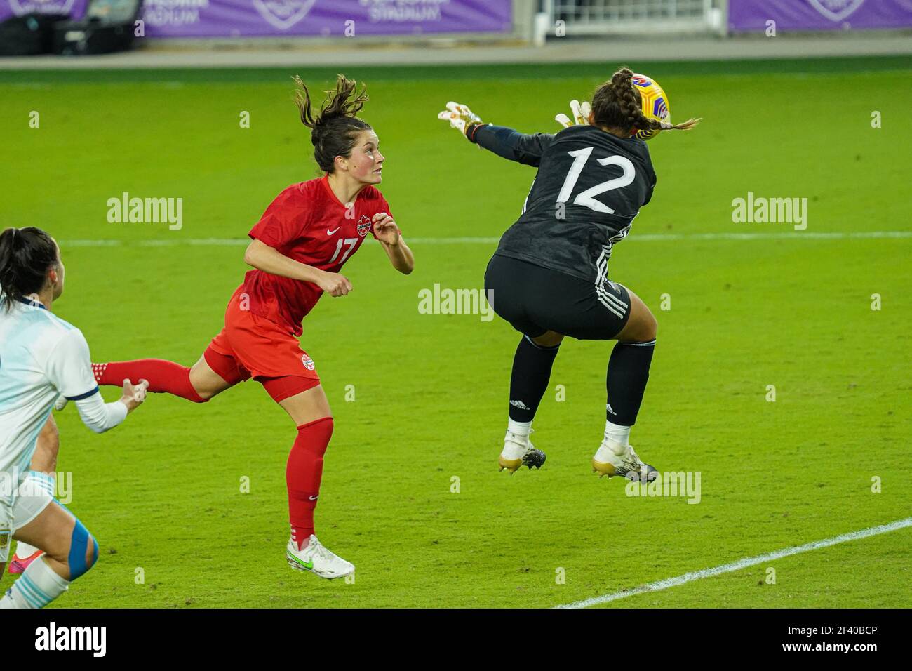 Orlando, Florida, USA, February 21, 2021, Canada's Jessie Fleming makes a header as Argentina's Goalkeeper misses during the SheBelieves Cup at Exploria Stadium  (Photo Credit:  Marty Jean-Louis) Stock Photo