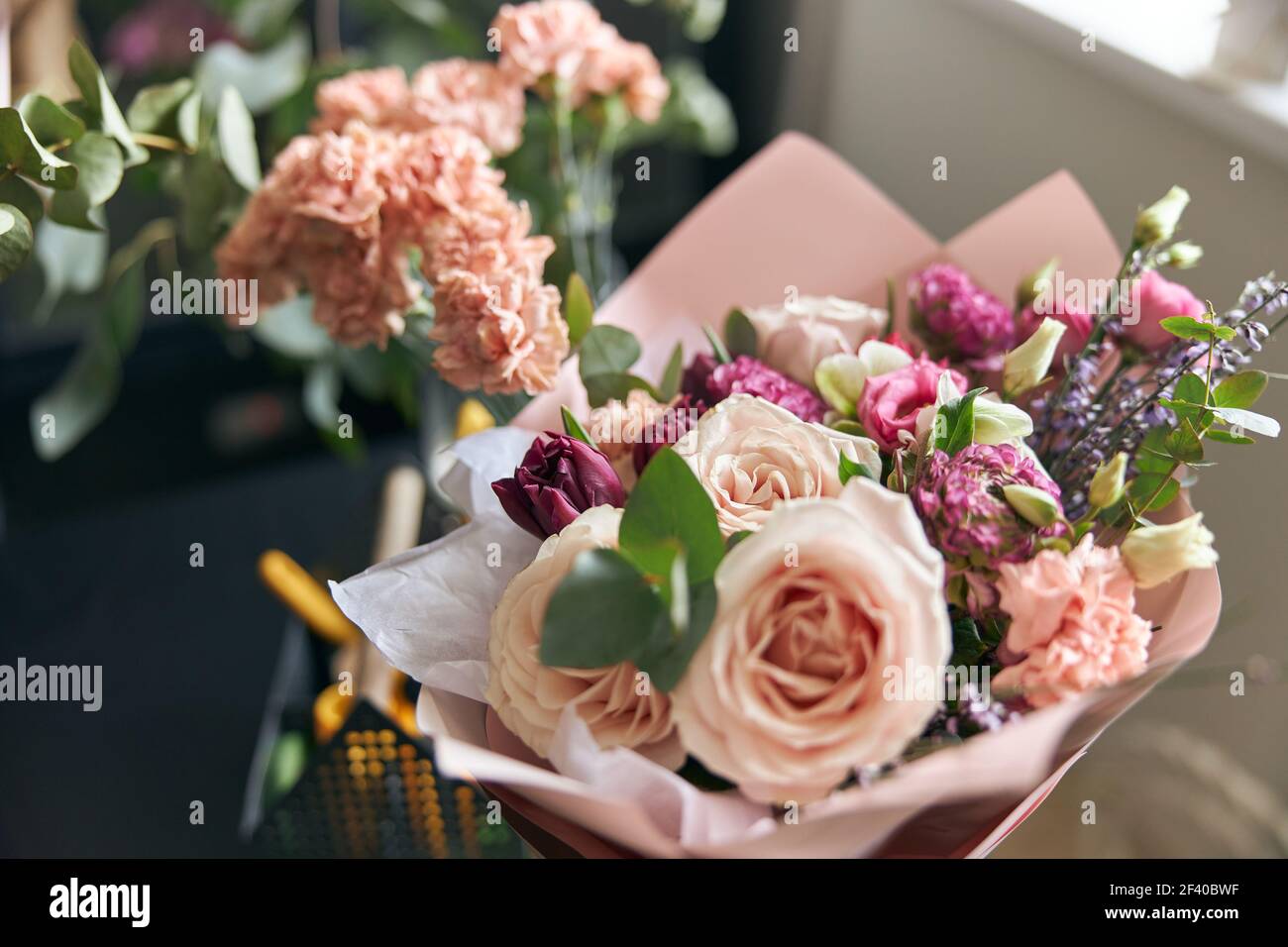 Nice and colorful bouqette of different flowers in flower shop. Close up. Stock Photo
