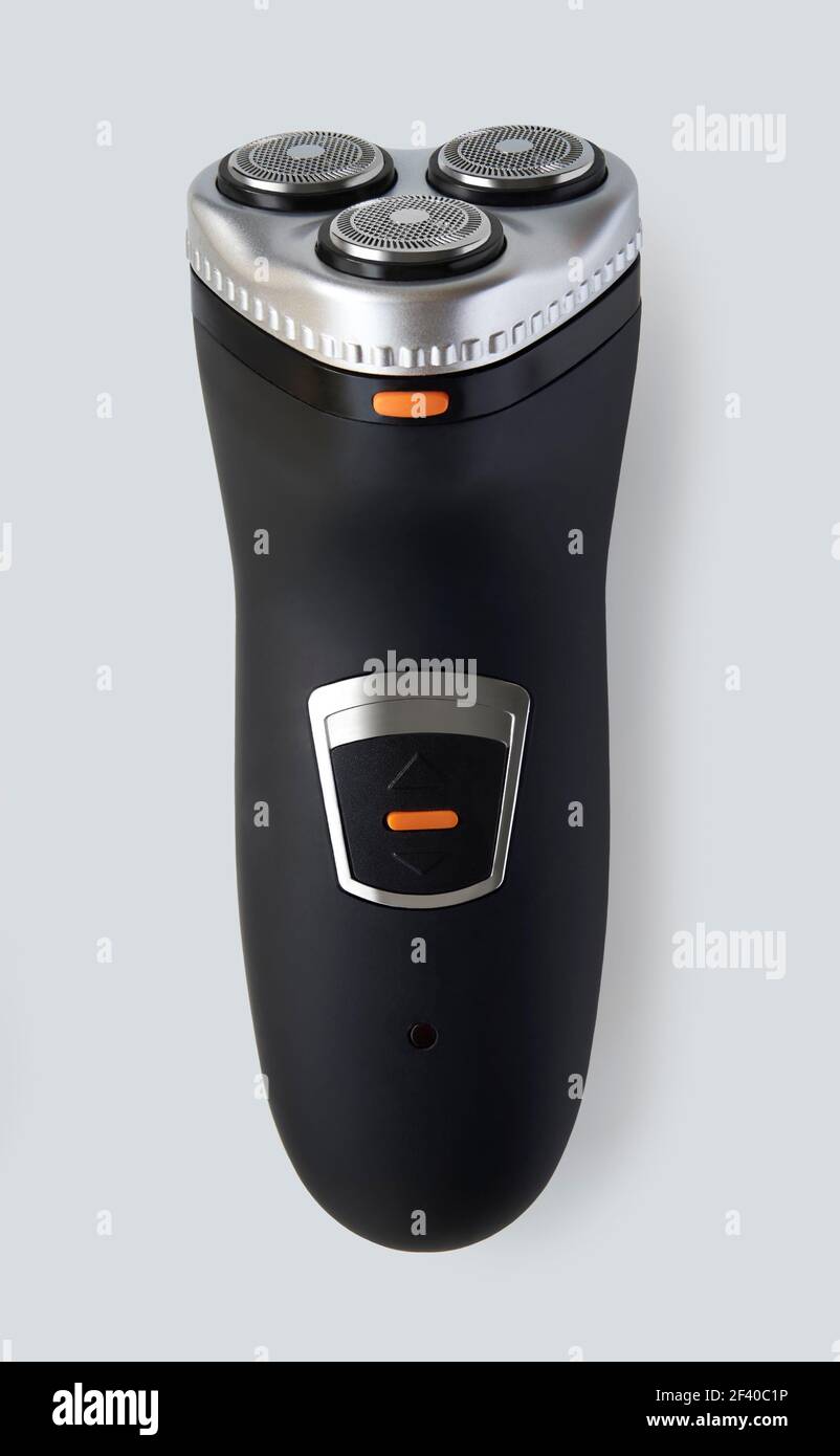 Overhead view of cordless electric razor isolated on white background