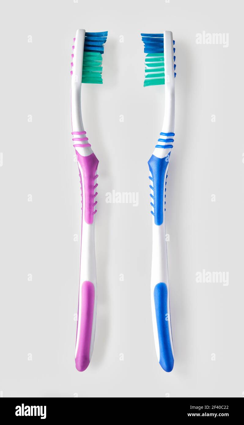Overhead view of his and hers toothbrush on white bacground Stock Photo