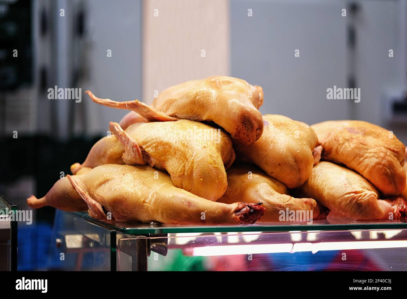 Fresh raw poultry meat is sold on counter of local farmers market. Stock Photo