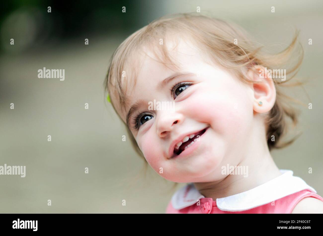 Adorable little girl playing in a urban park Stock Photo - Alamy