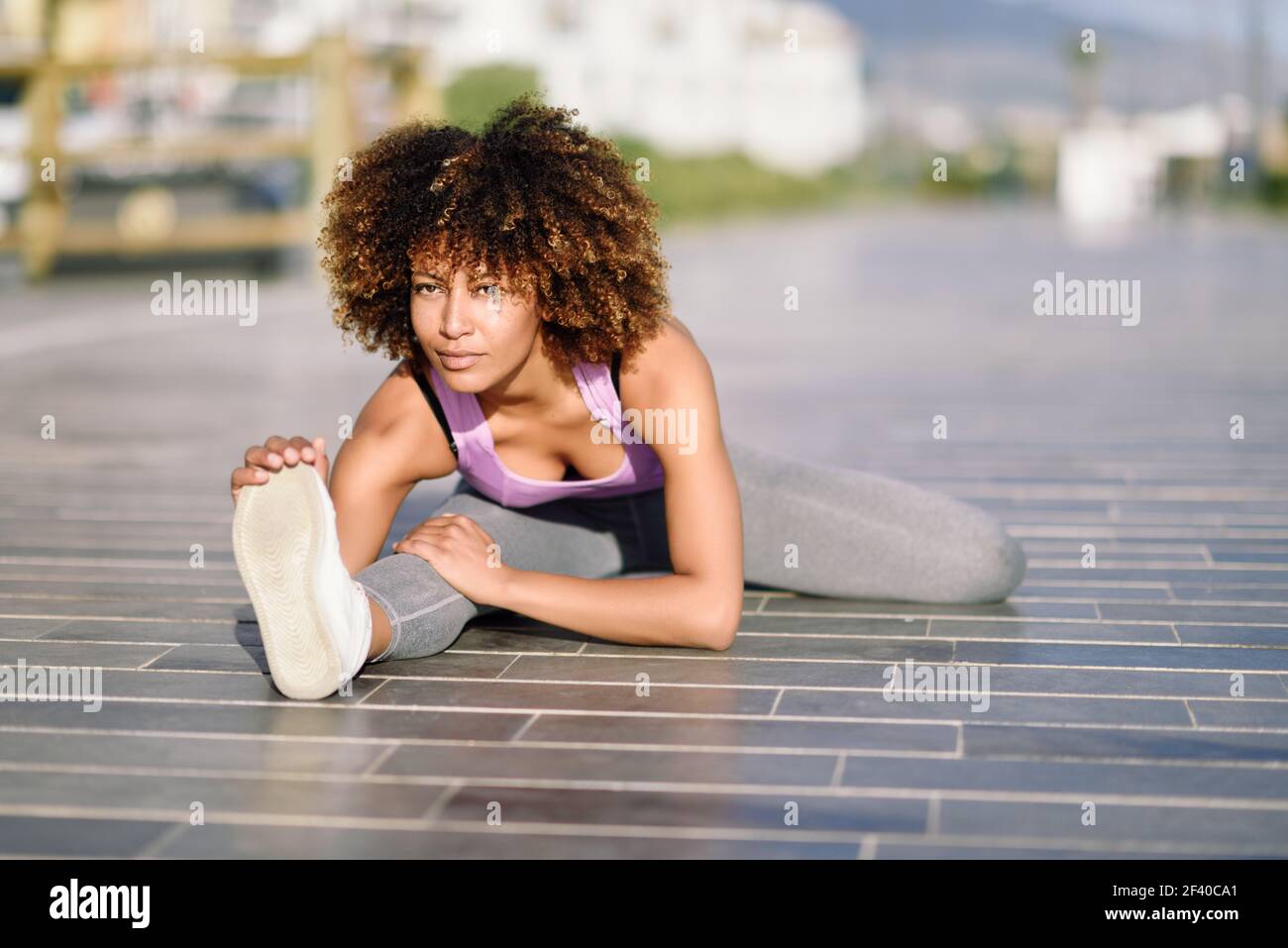 young-black-woman-doing-stretching-after-running-outdoors-girl