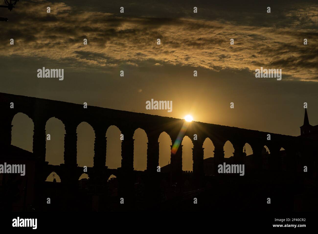View of the famous Aqueduct of Segovia at Sunset. Roman construction of the 1st century. Travel concept. Spain, Castile and Leon, Segovia. Stock Photo