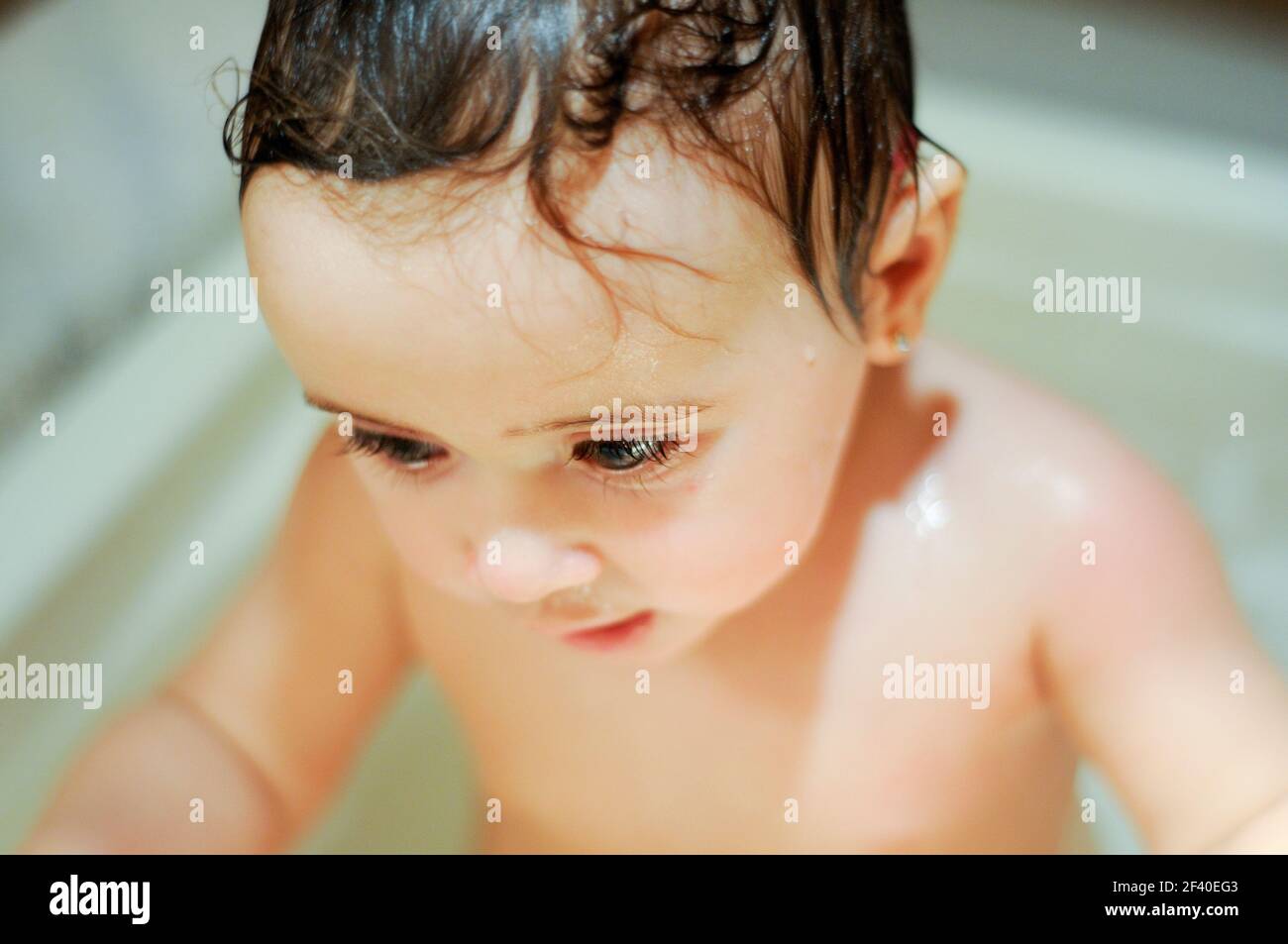 Baby girl six months old having her bath and crying Stock Photo Alamy