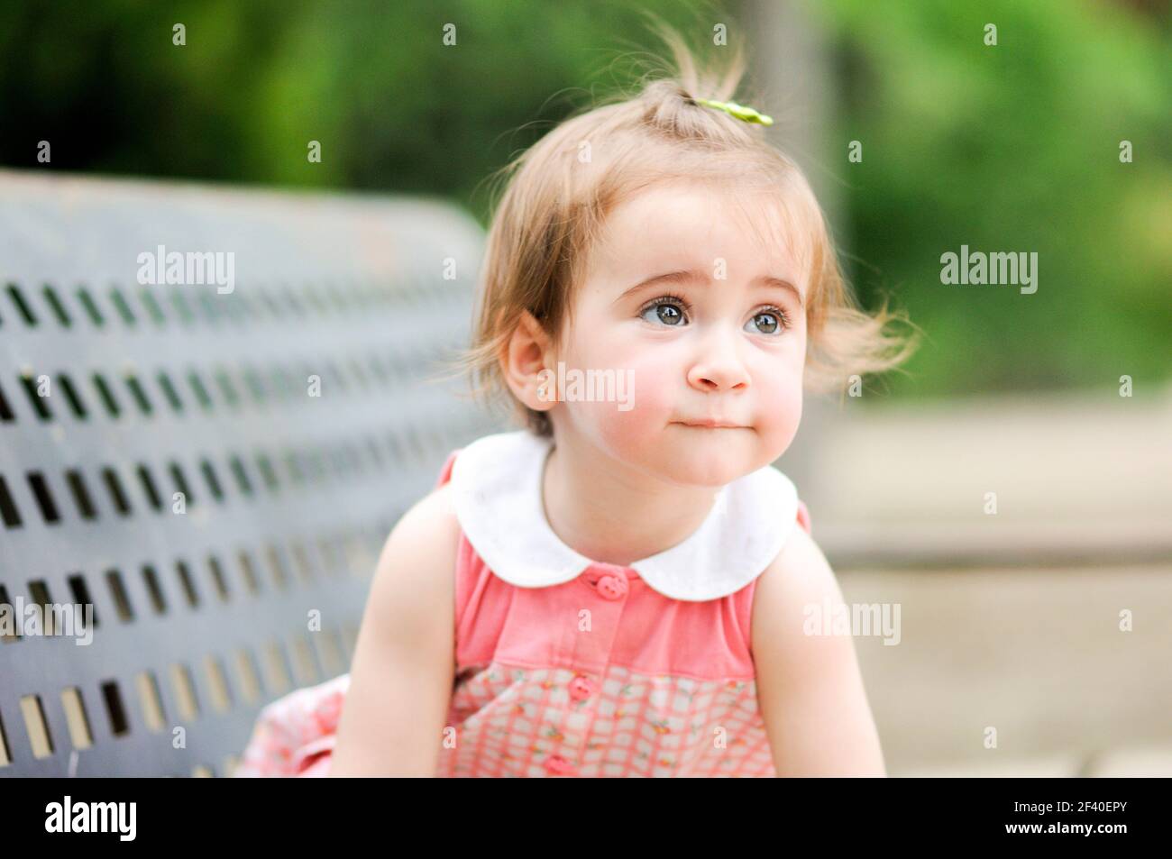 Adorable little girl playing in a urban park Stock Photo - Alamy