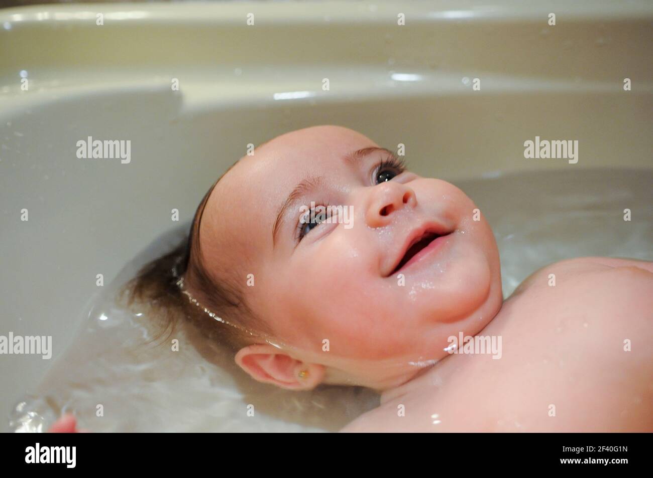 Baby girl four months old having her bath and crying Stock Photo Alamy