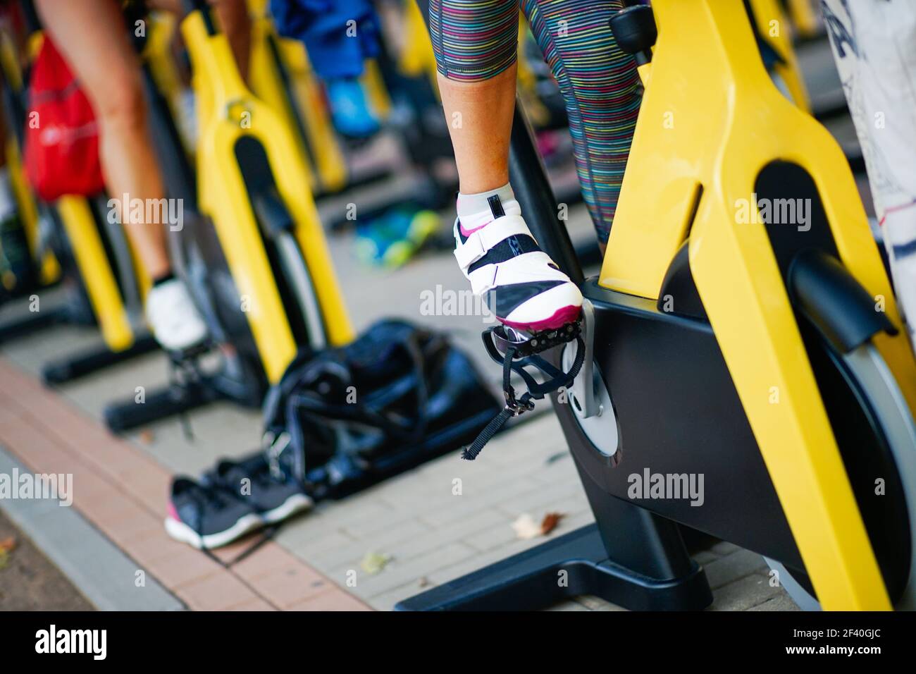 People training at a gym doing cyclo indoor. Sports and fitness concept.. People training at a gym doing cyclo indoor. Stock Photo