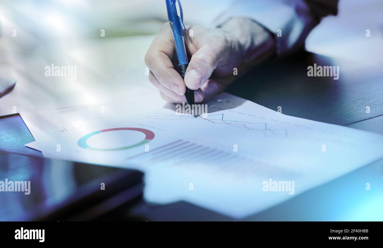 Businessman analyzing graphics at office, light effect Stock Photo - Alamy