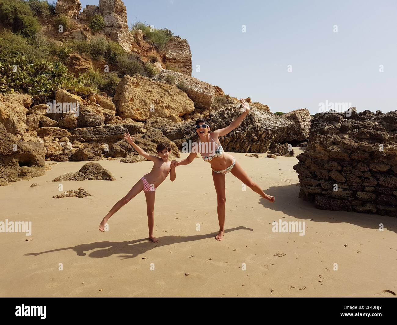 Mother and little daughter having fun on the beach of the Wall of Puerto Sherry, in Puerto de Santa Mar a, C diz, Andalusia, Spain.. Mother and little daughter having fun on the beach Stock Photo