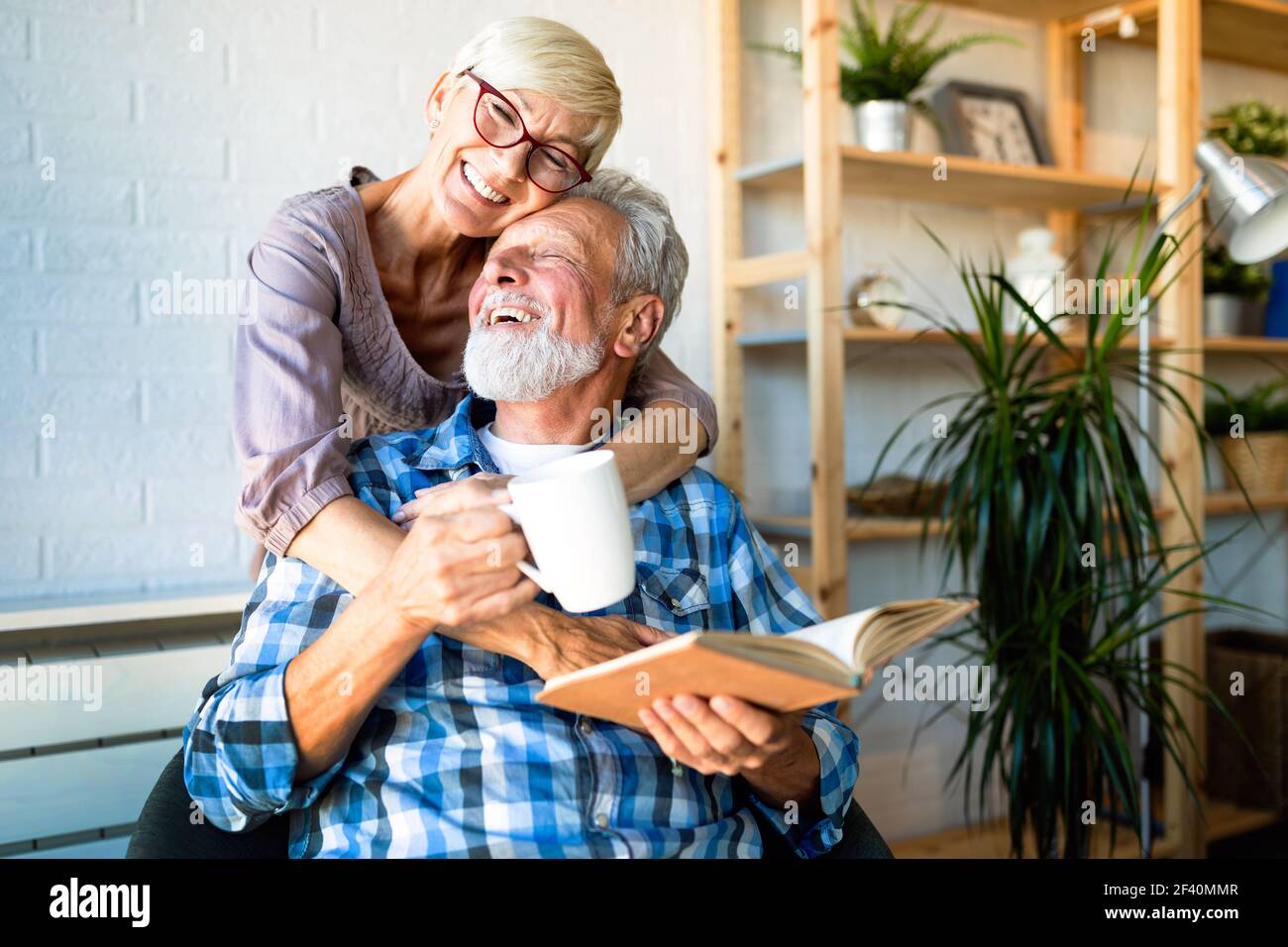 Happy senior couple relaxing at home together Stock Photo - Alamy