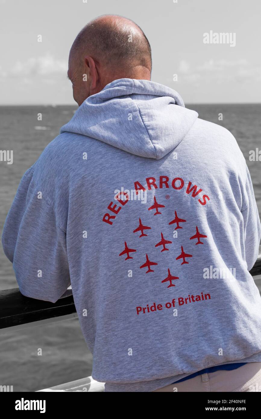 Man wearing Red Arrows Pride of Britain grey hoody at Bournemouth Air Festival, Bournemouth, Dorset UK in August Stock Photo