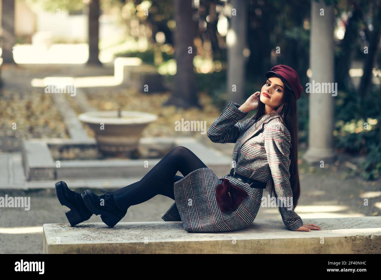 Lady with a hat sitting on a bench hi-res stock photography and images -  Alamy