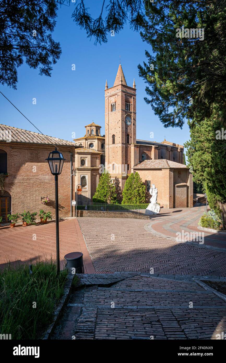 Ancient Church Abbazia di Monte Oliveto Maggiore with Statue and Road. Asciano, Siena, Tuscany, Italy, Europe. Stock Photo