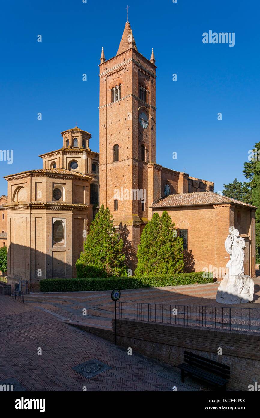 Ancient Church Abbazia di Monte Oliveto Maggiore with Statue and Road. Asciano, Siena, Tuscany, Italy, Europe. Stock Photo