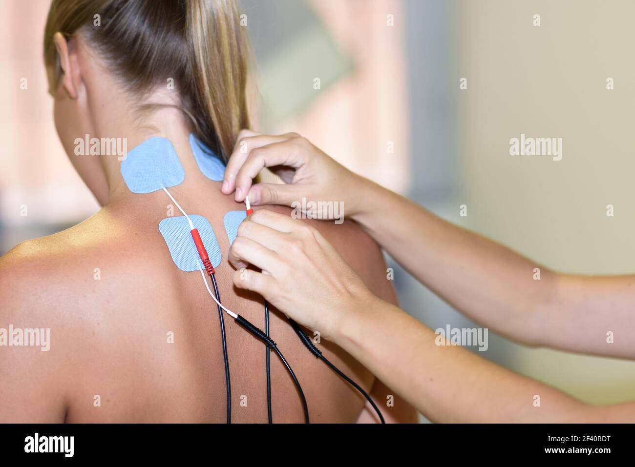Patient having electrode therapy, or electrical muscle stimulation, on a  knee joint using electrical stimulation to treat muscle pain and prevent  atro Stock Photo - Alamy
