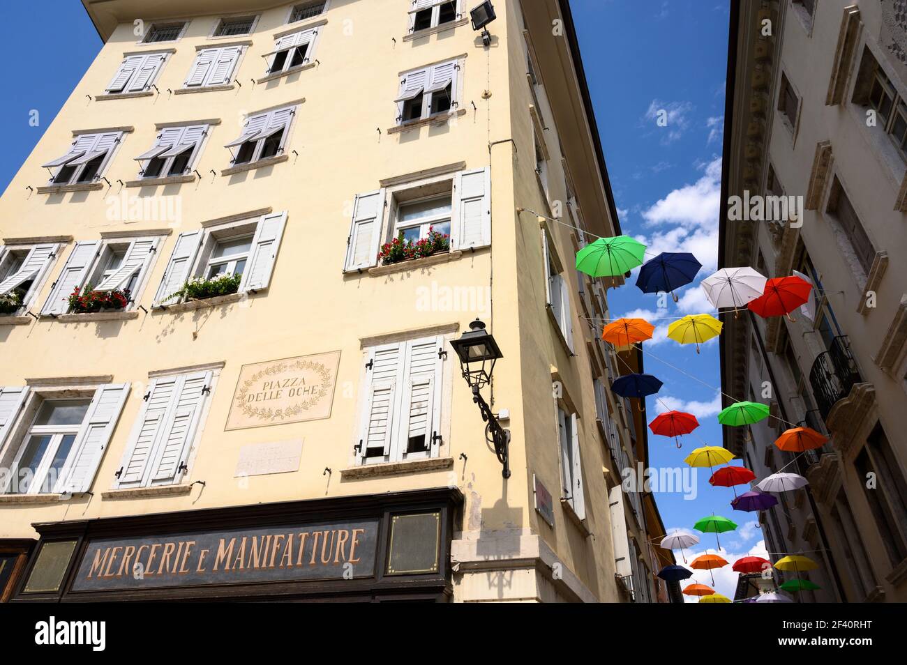 Rovereto. Italy. Colourful umbrellas on Piazza Cesare Battisti (Piazza delle Oche) in the historic centre of the town. Stock Photo