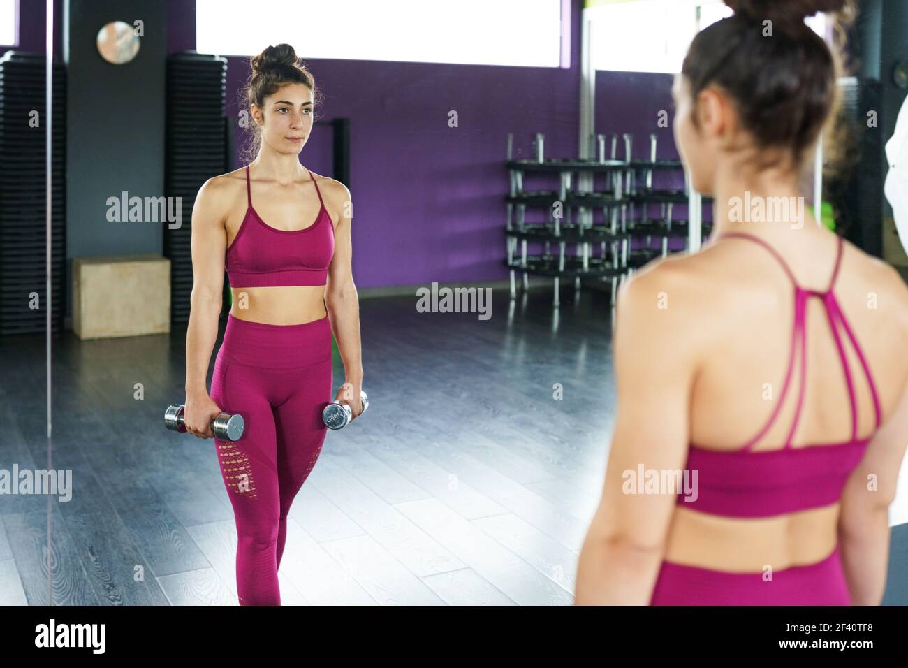 Sporty woman punching and boxing with dumbbells. Hard exercising and  training at the gym. Fitness concept.. Sporty woman punching and boxing  with dumbbells Stock Photo - Alamy