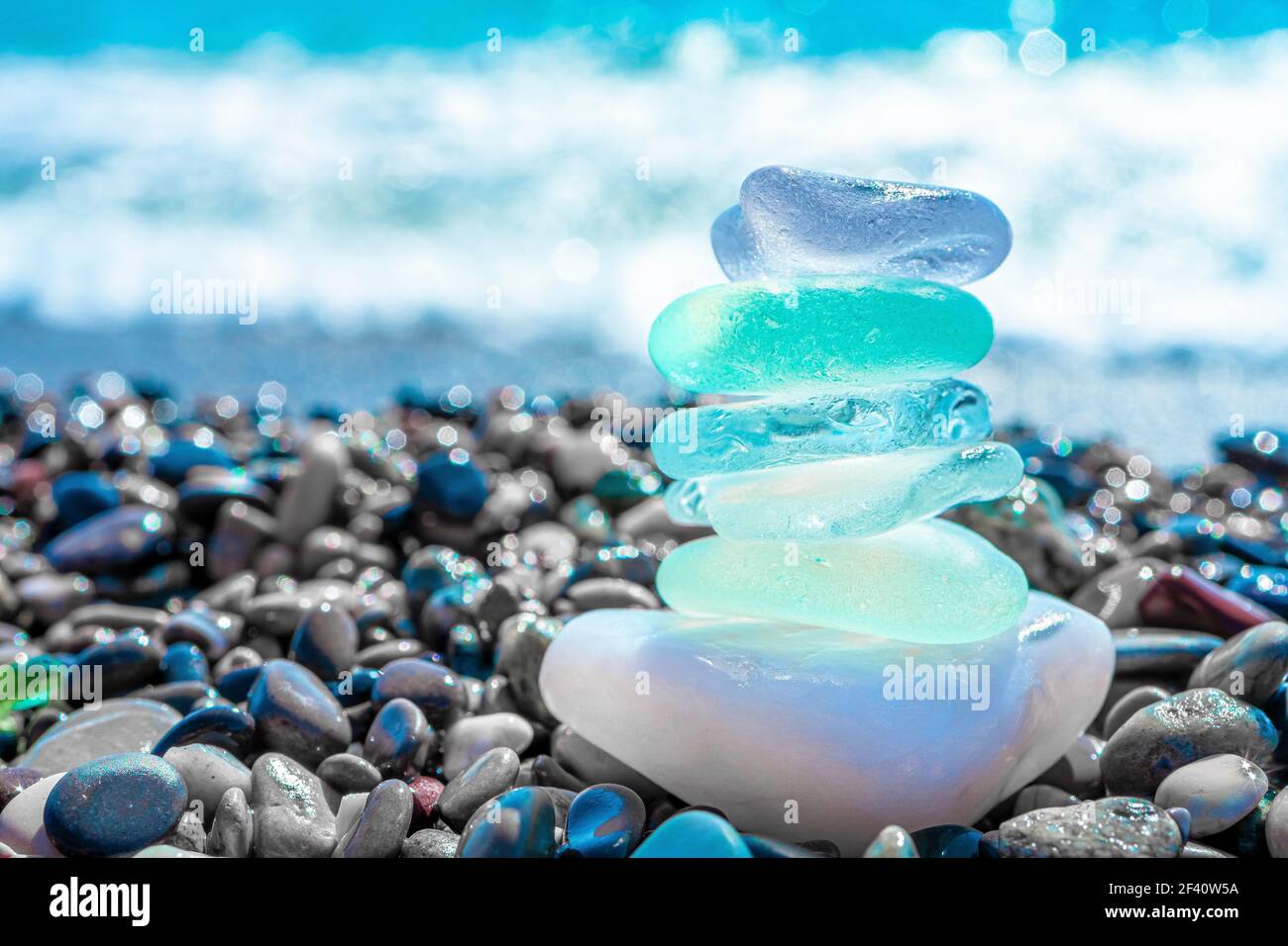 Sea glass stones arranged in a balance pyramid on the beach Beautiful  azure color sea with blurred seascape background Meditation and Harmony  concep Stock Photo  Alamy