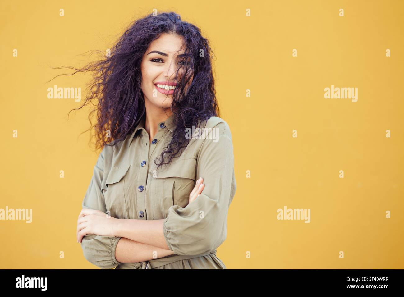 Funny Arab Woman with curly hair in urban background. Young Arab Woman with curly hair outdoors Stock Photo